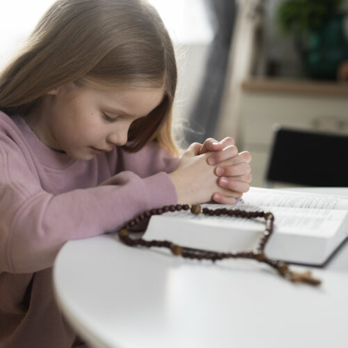 medium shot girl praying home