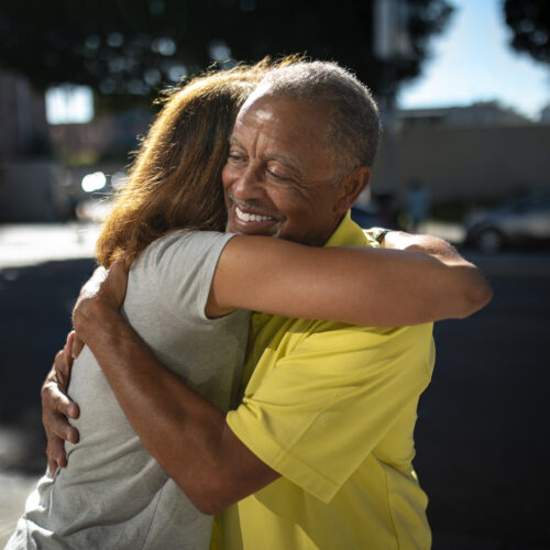 medium shot senior people hugging outdoors